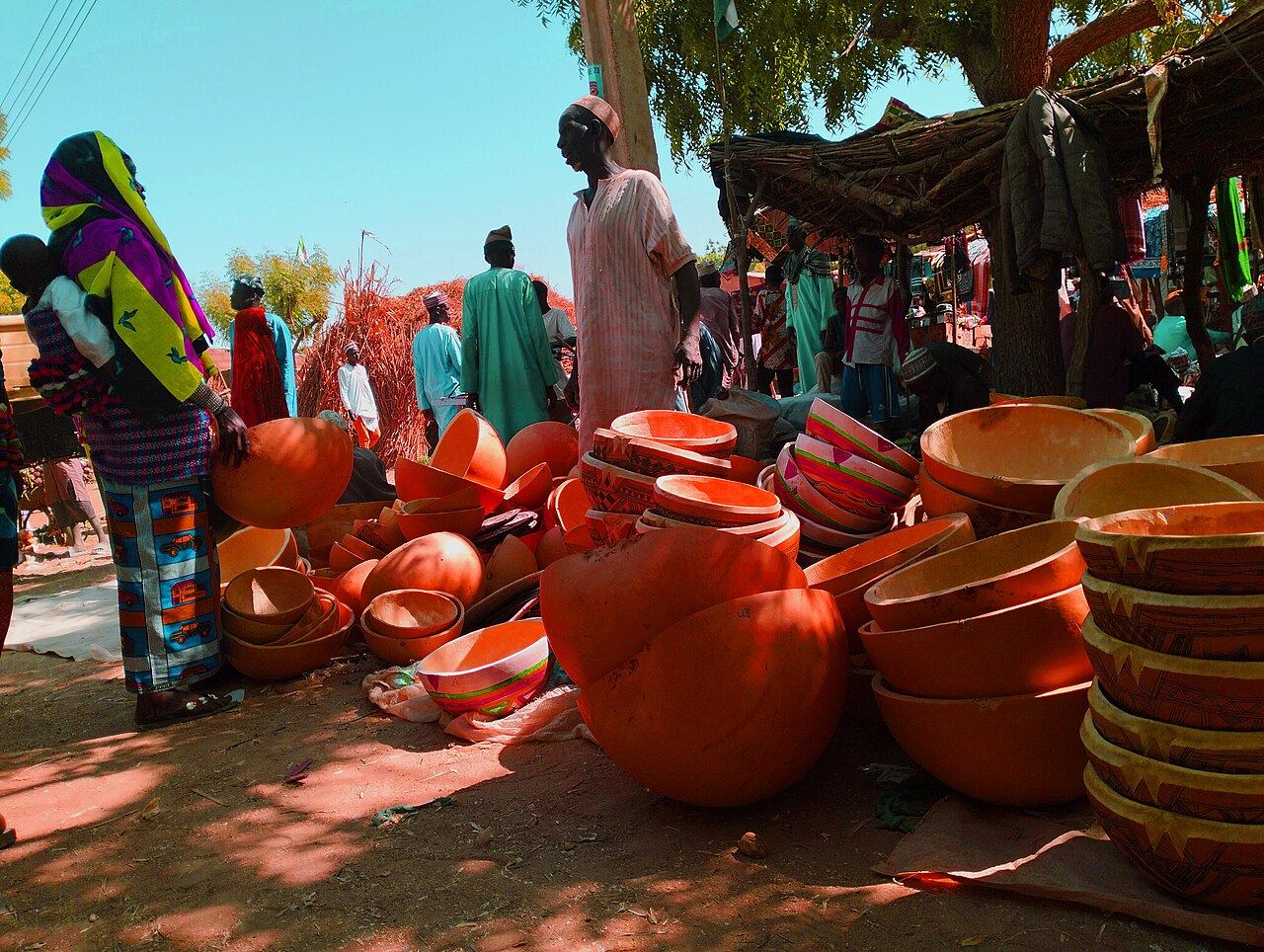 A Fulani woman buying a calabash at Kolere Market in Nigeria