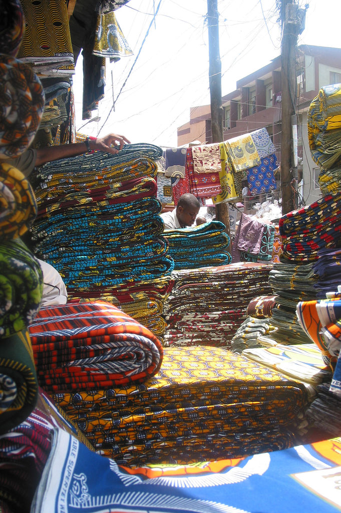 A shopper browsing a cloth market in Lagos, Nigeria