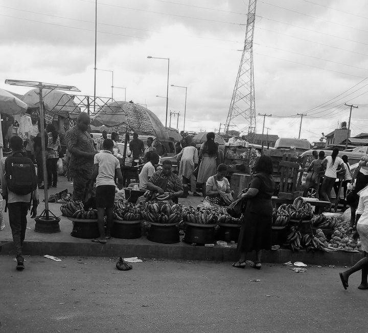 Traders making sales to customers at a Lagos market