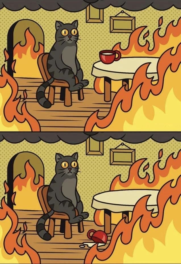 a cartoon cat sitting on a table in front of a fire
