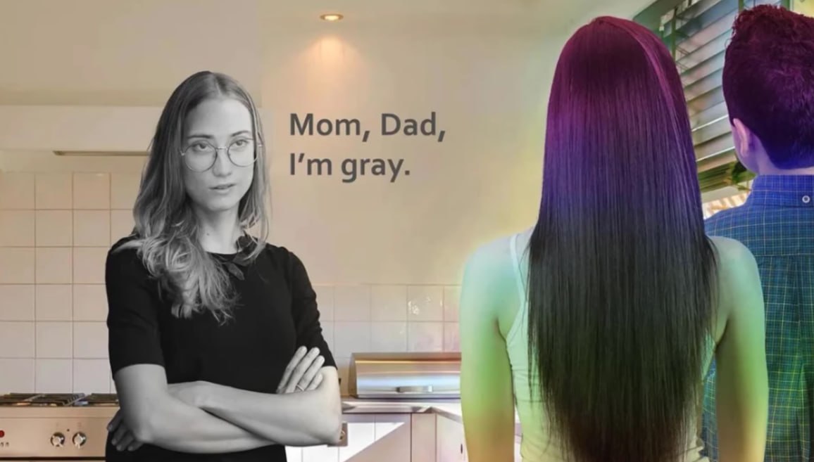 a woman with long hair standing in front of a kitchen
