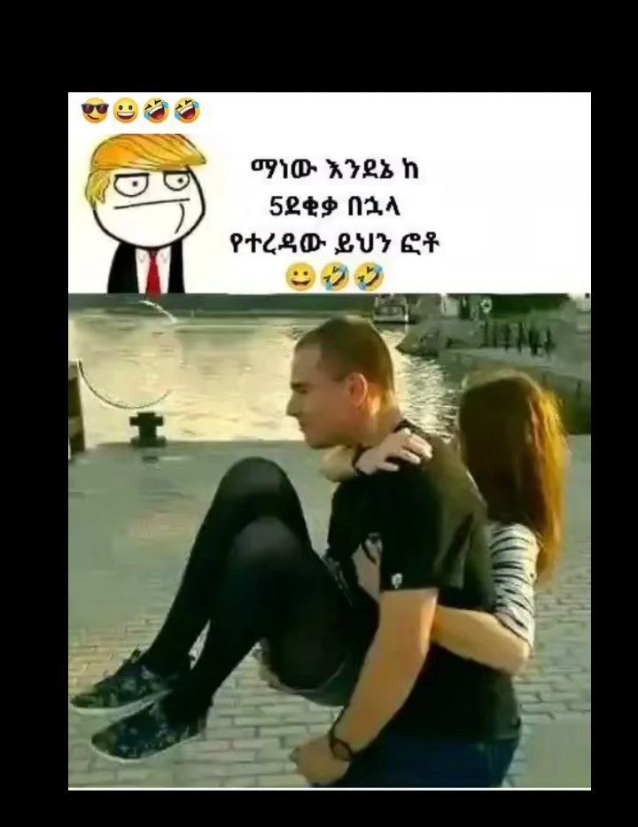 a man and woman are kissing in front of a building