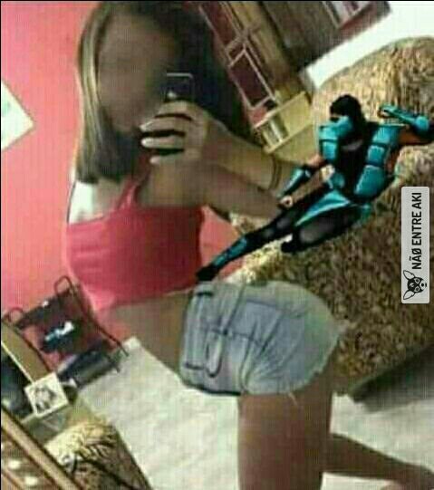 a woman in shorts and a pink shirt is taking herself