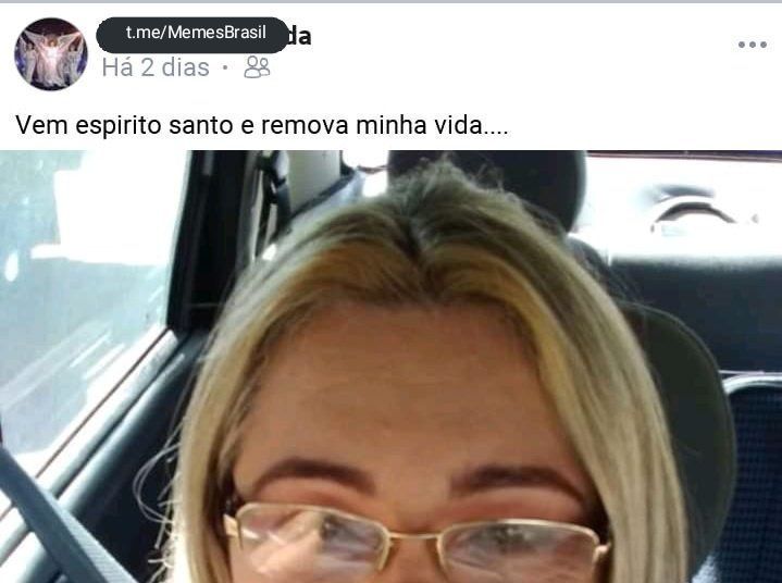 a woman with glasses sitting in a car