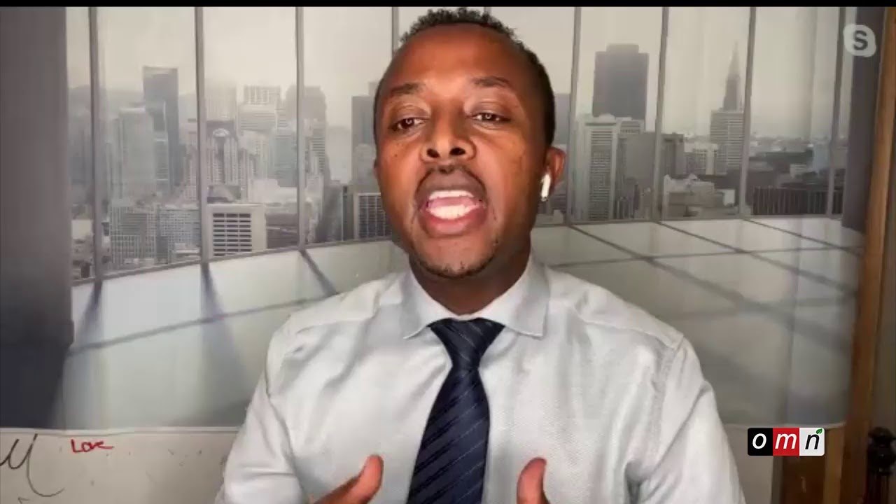 a man in a white shirt and tie is talking