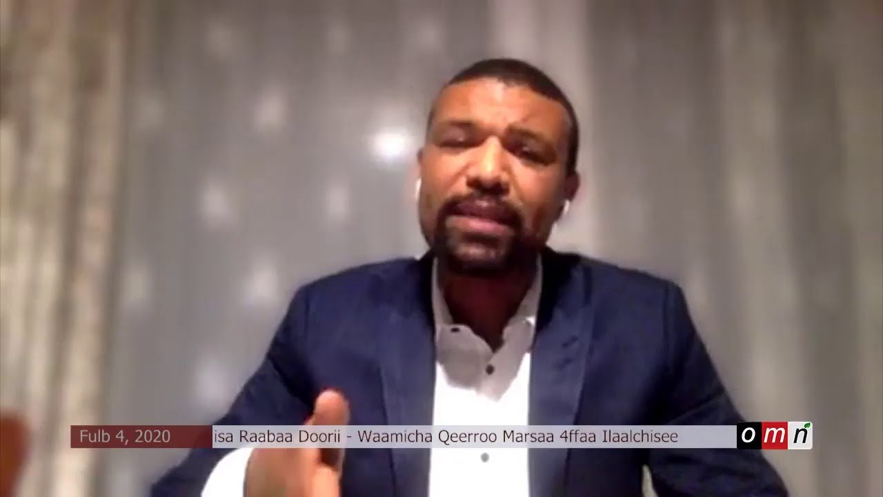 a man in a suit and tie is talking to the camera