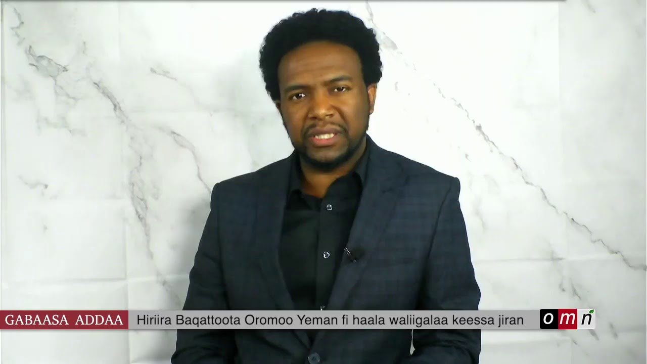 a man in a suit and tie is sitting down