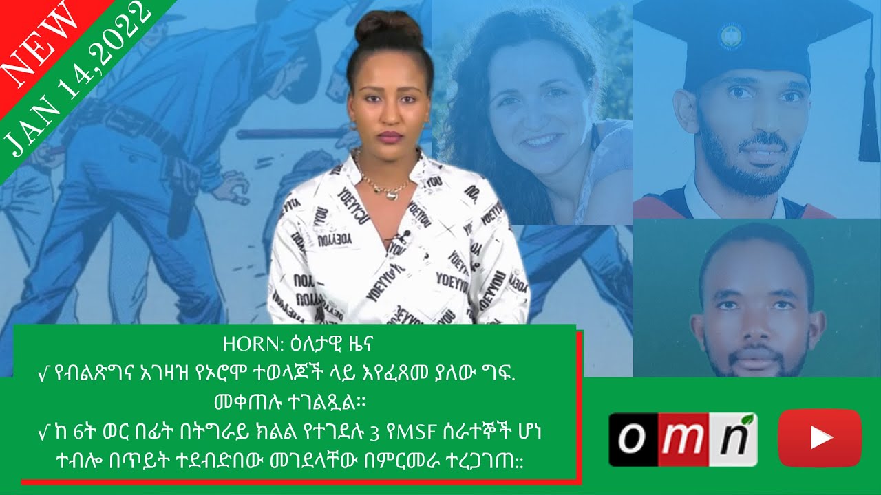 a woman in a white shirt and black pants is smiling at the camera with a green background