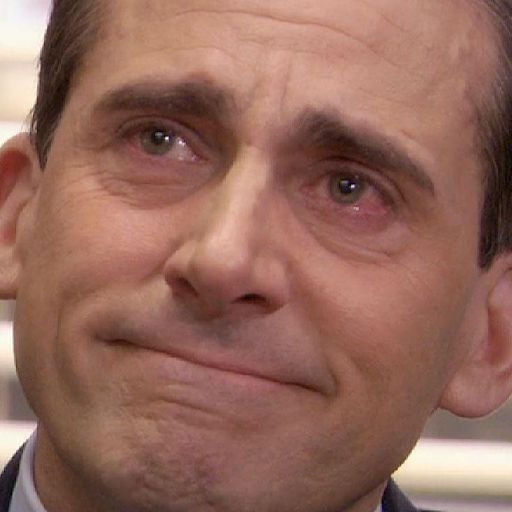 a man in a suit and tie is looking at the camera