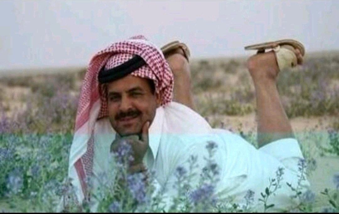 a man in a field with a hat on