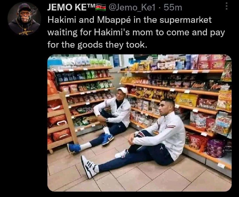 a man sitting on the floor in front of a store